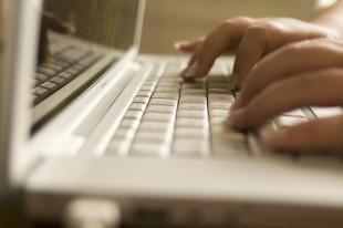 Woman typing on her computer