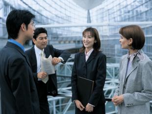 Business woman interviewing with a team of businessmen and women